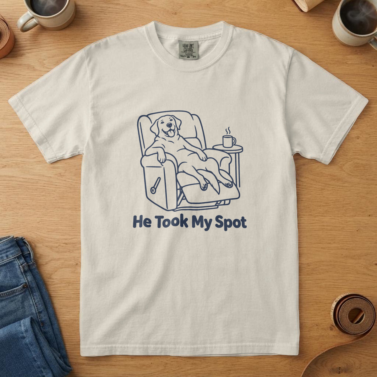 Ivory t-shirt with a navy line drawing of a dog in a recliner and the words "He Took My Spot"
