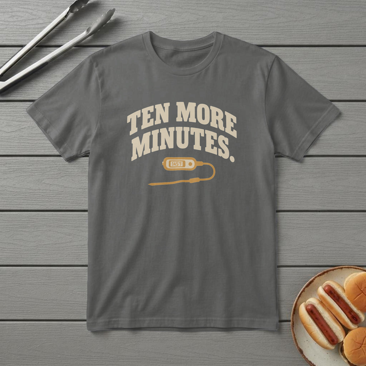 Pepper t-shirt with cream type reading "Ten More Minutes." above a meat probe thermometer, on a grey deck