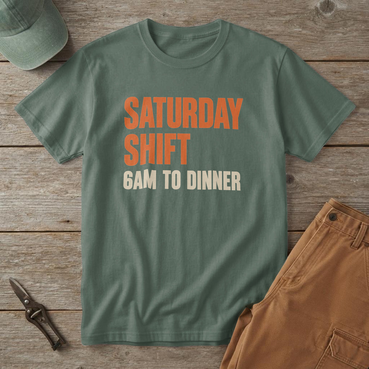 Blue Spruce t-shirt with orange "Saturday Shift" and cream "6AM to Dinner" type, on a cedar picnic table