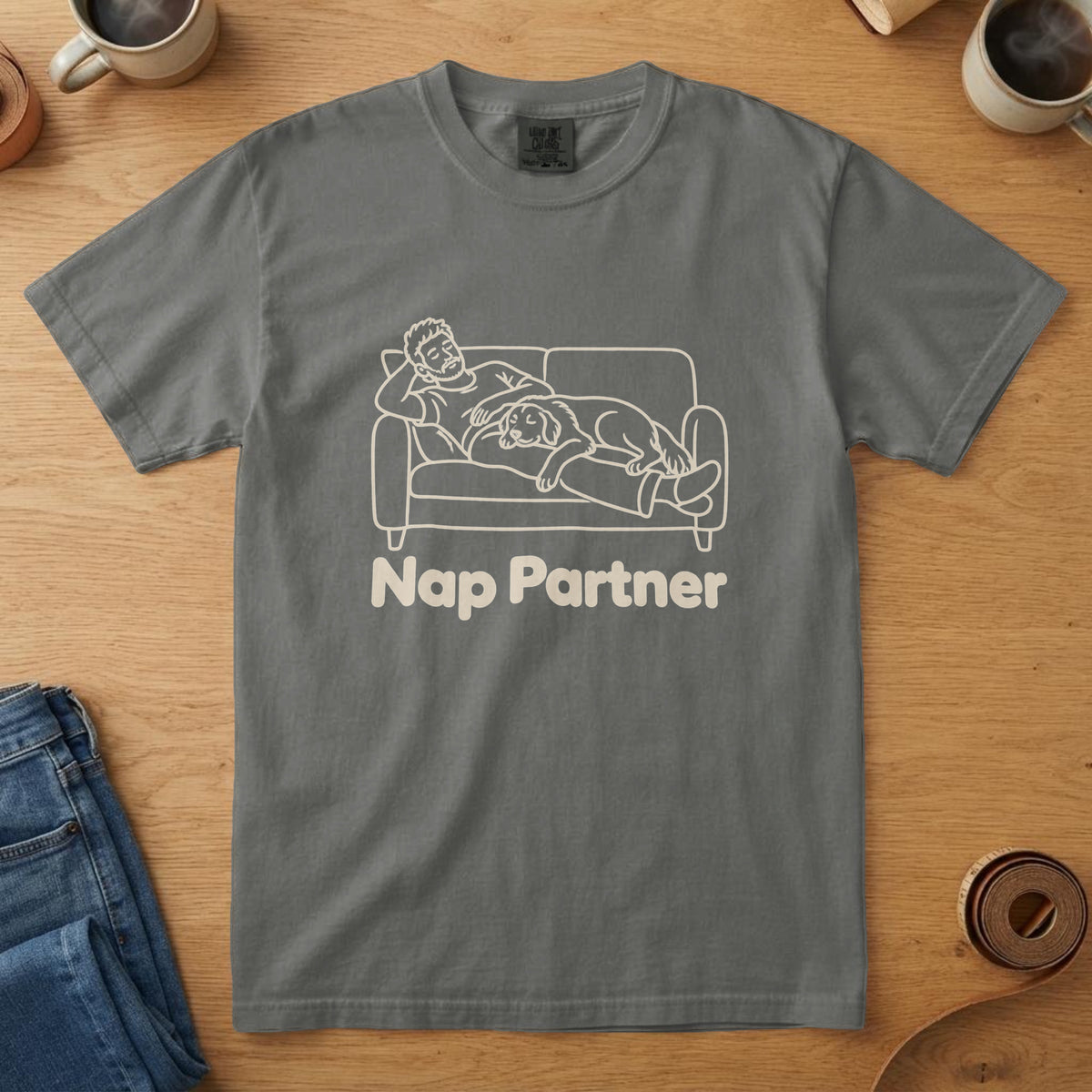 Pepper t-shirt with a bone line drawing of a man napping on a couch with a dog and the words "Nap Partner"