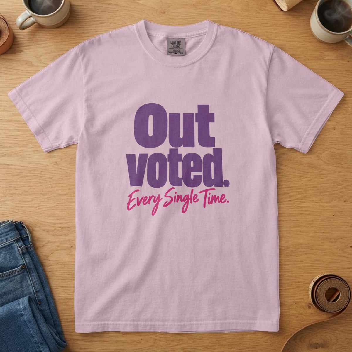 Blossom t-shirt with big plum lettering with a pink script line and the words "Outvoted. Every Single Time."