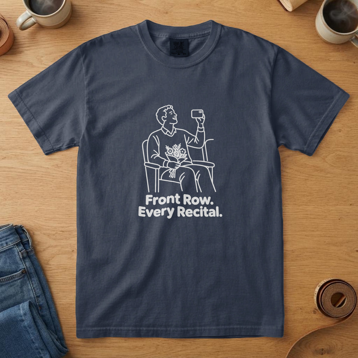 Navy t-shirt with a white line drawing of a dad filming a recital and the words "Front Row. Every Recital."
