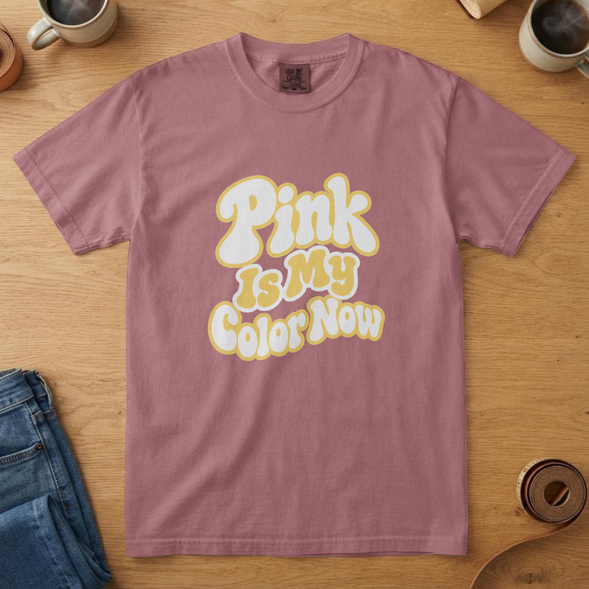 Crimson t-shirt with chunky white and yellow lettering and the words "Pink Is My Color Now"