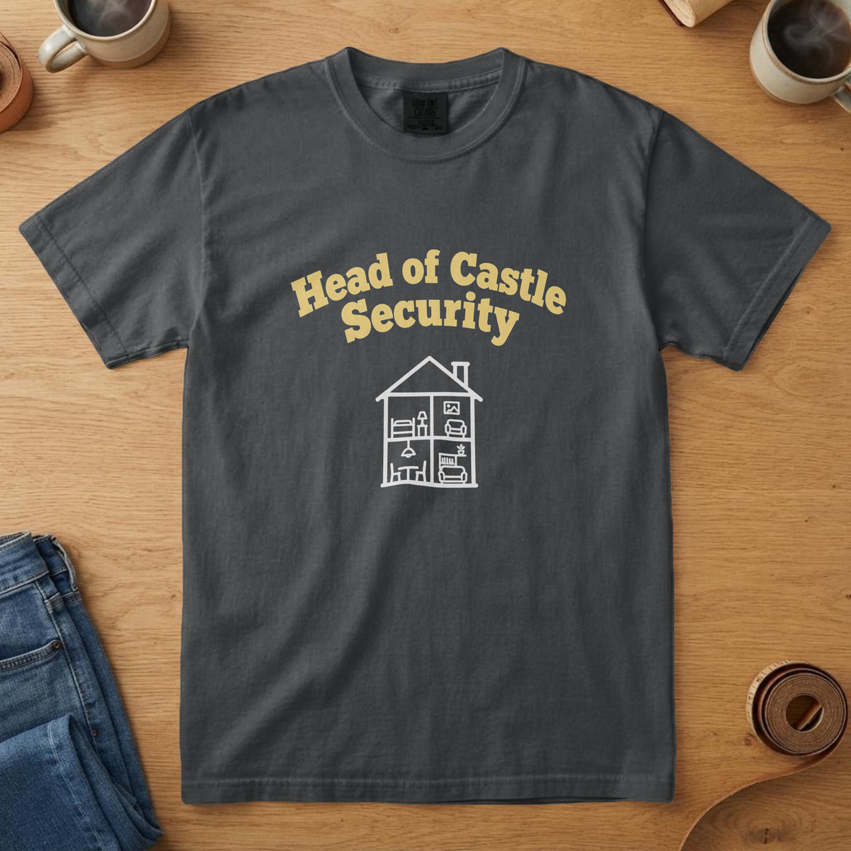 Black t-shirt with yellow lettering above a white dollhouse drawing and the words "Head of Castle Security"